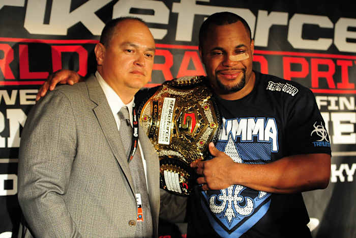 Former Strikeforce CEO and Bellator president Scott Coker (l.) poses with Daniel Cormier in 2012.